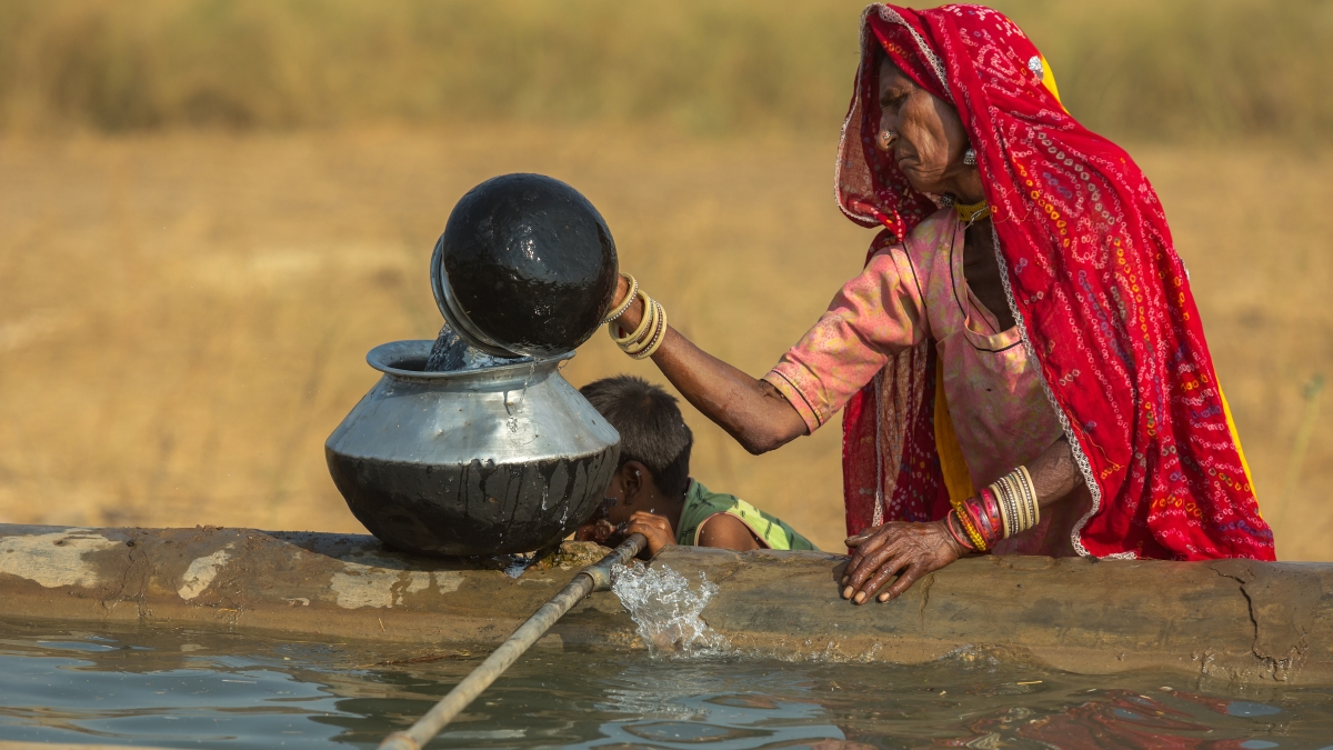 Indian woman gets water from well