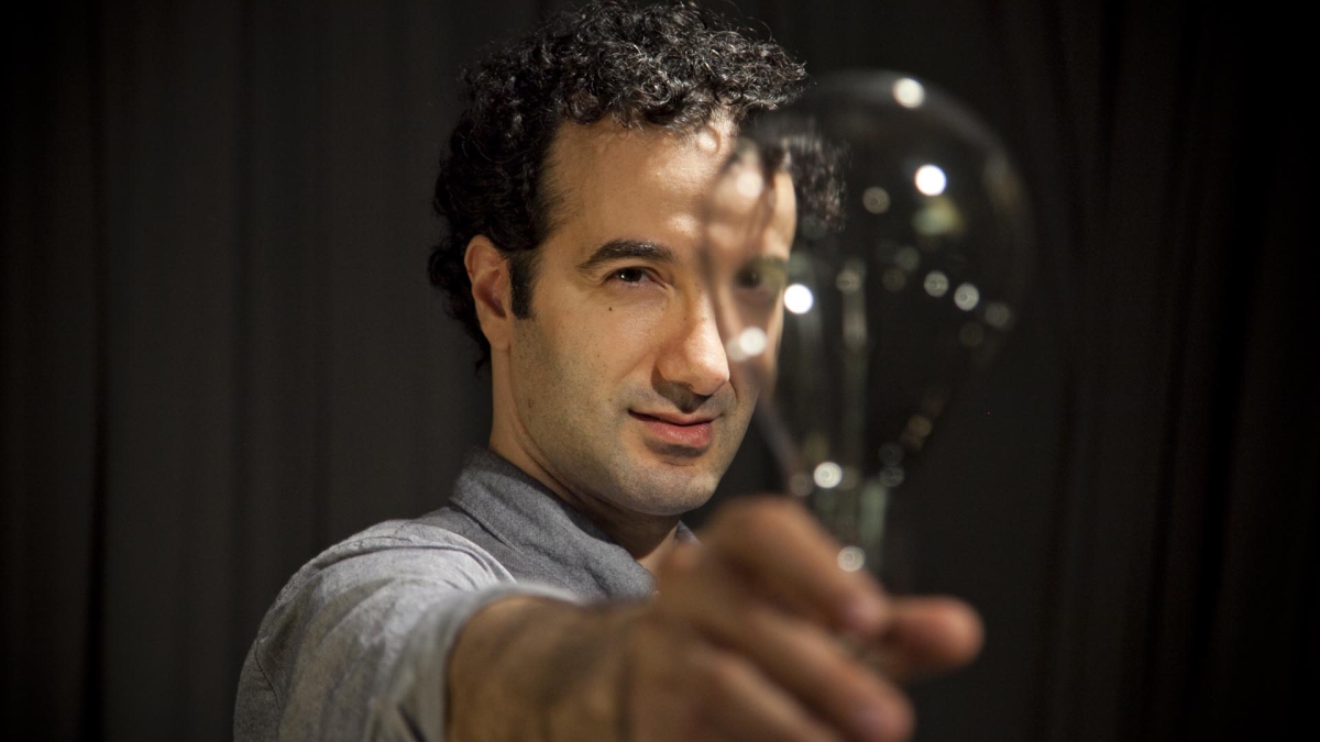 Radiolab creator and host Jad Abumrad holding a lightbulb