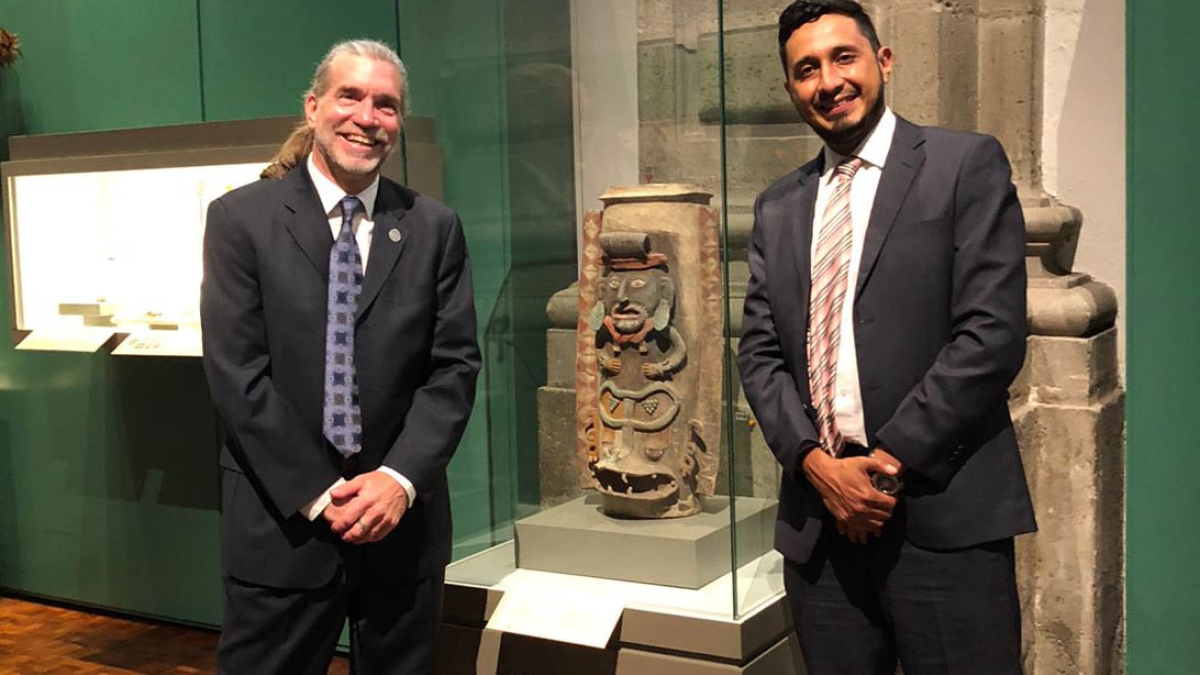 Joel Palka and collaborator, archaeologist Josuhé Lozada, next to the repatriated Maya urn from Albion College on exhibit in Mexico City.