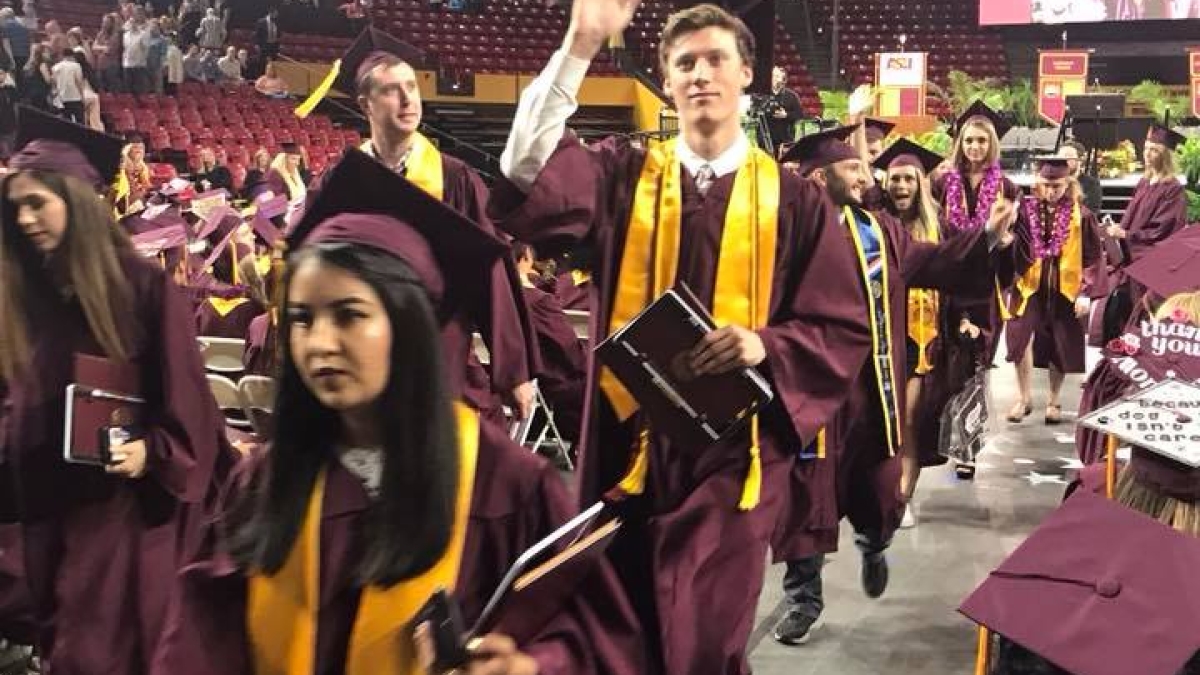 ASU Polytechnic campus political science graduate Kyle Hohmann processes out of Wells Fargo Arena after CISA Convocation