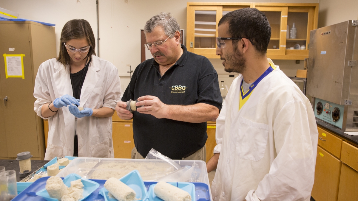 Photo of three people in a lab. Caption: ASU geotechnical engineering expert Ed Kavazanjian (middle) earned the American Society of Civil Engineers' highest honor for his outstanding career achievements.