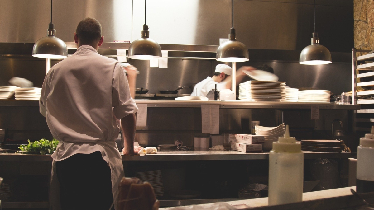 A crew works in a restaurant kitchen