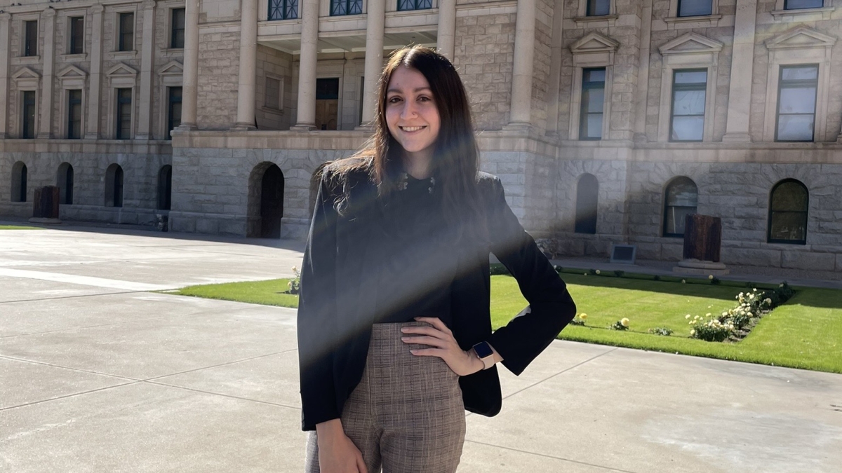 ASU grad Madison Woerner poses outside of the Arizona State Capitol