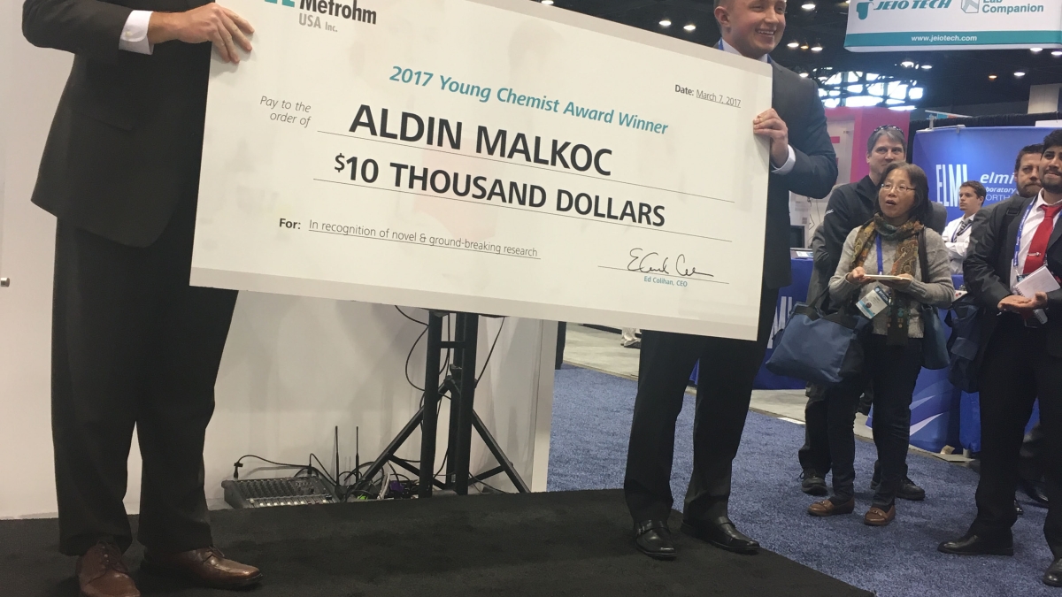 man accepting giant check
