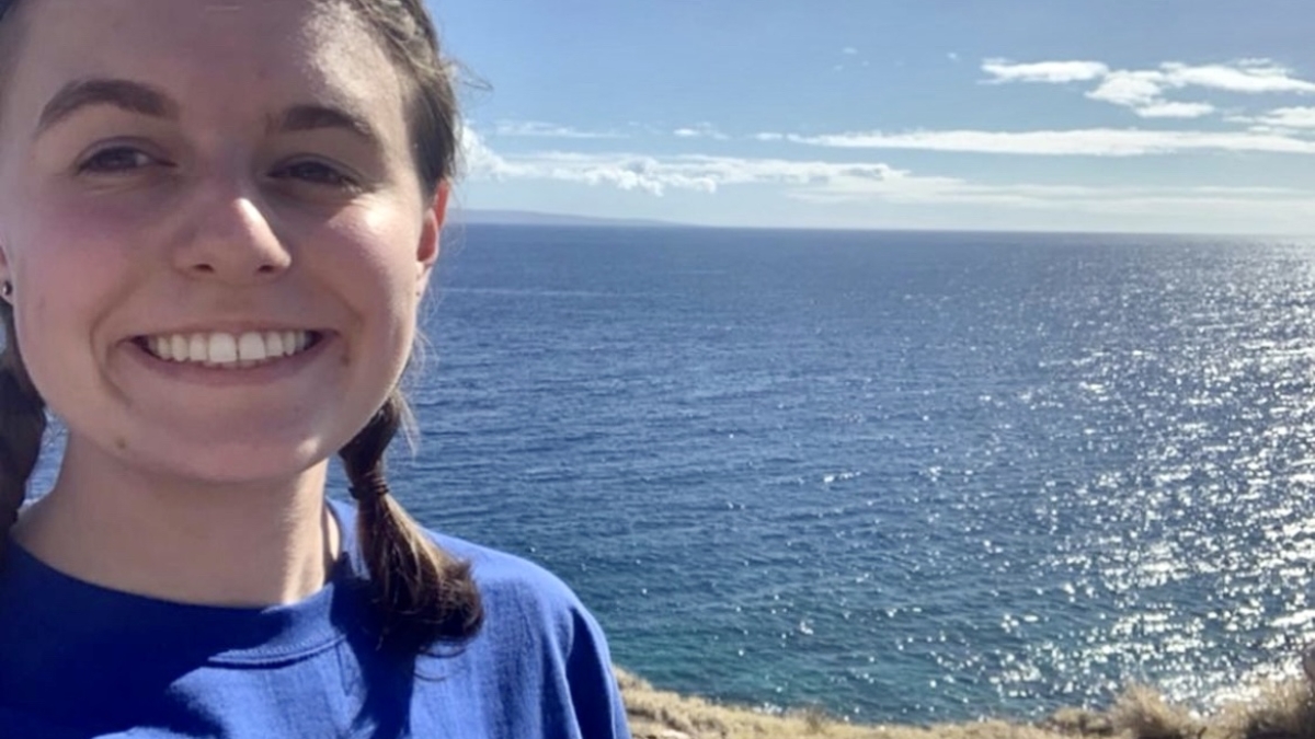 Smiling girl with ocean in background
