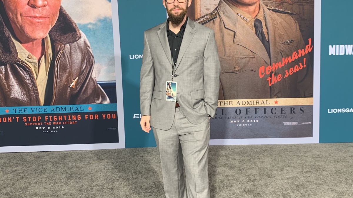 man standing in front of movie posters