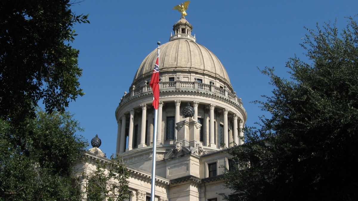 Dome of Mississippi capitol building with flag in foreground