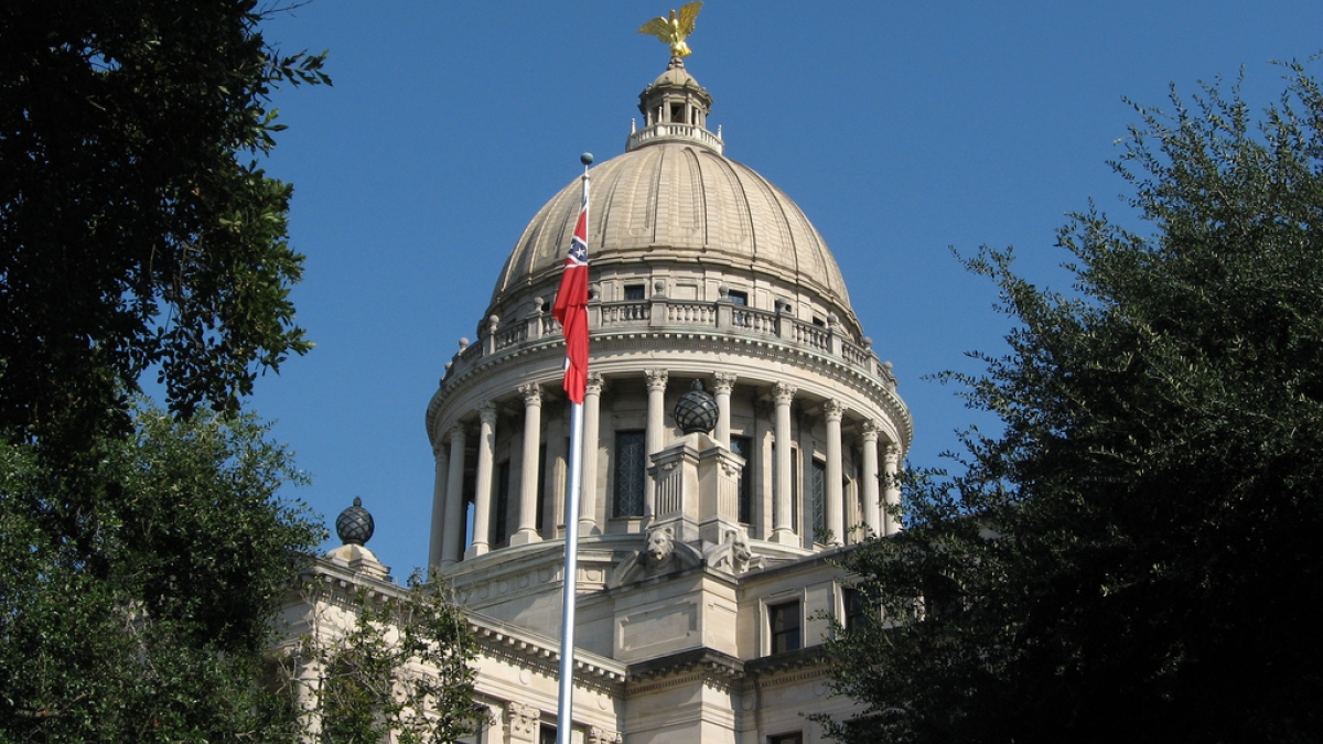 Dome of Mississippi capitol building with flag in foreground