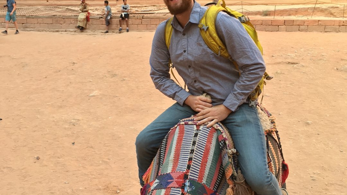 Man riding a camel at Petra in Jordan.