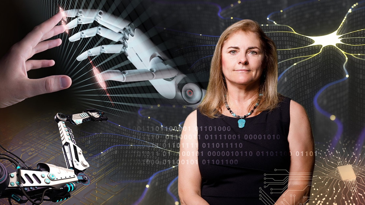 Portrait of woman in front of screen depicting robotics