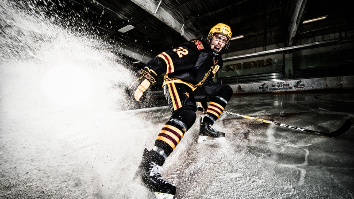 hockey player spraying ice into camera