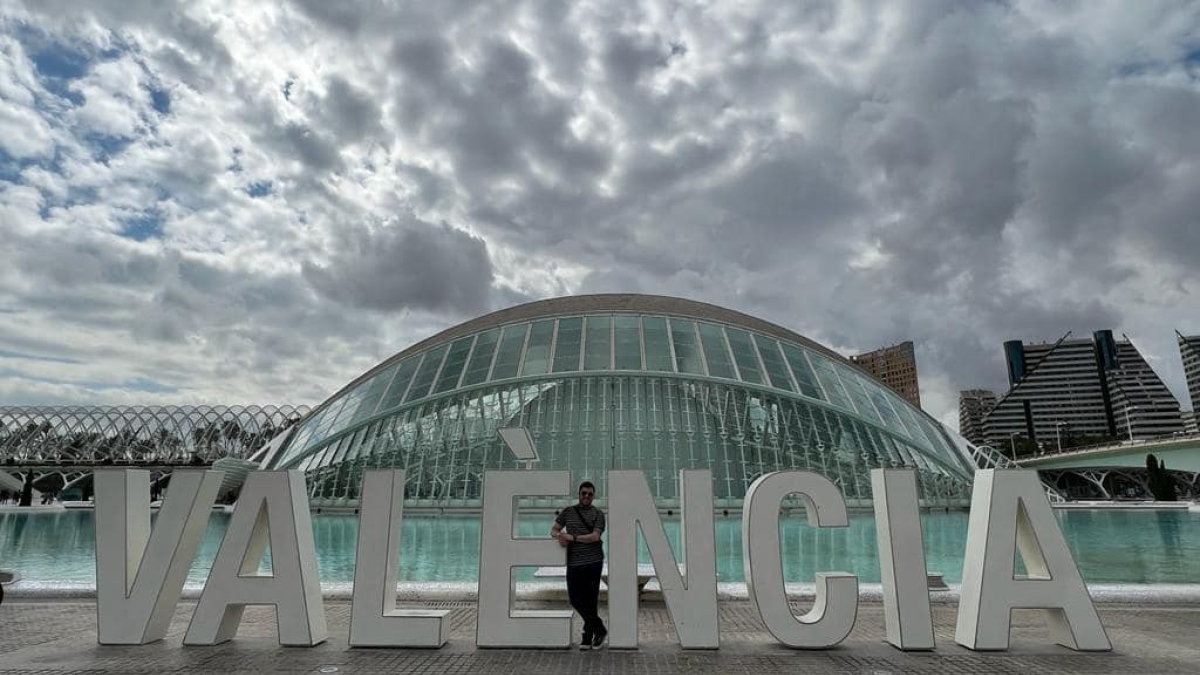 Large Valencia sign in Valencia, Spain, with landmark Hemisferic building in the background