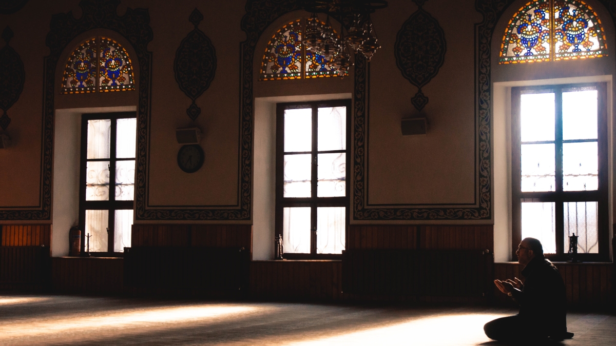 A person prays in a mosque.