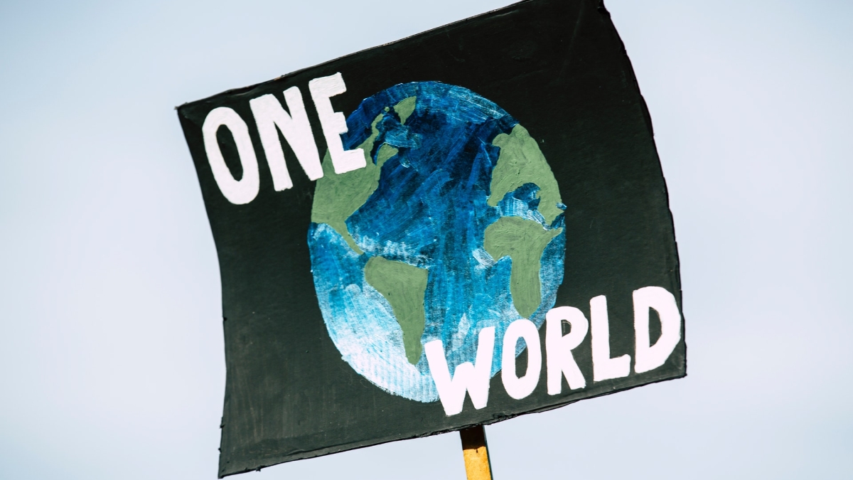 Poster with a drawing of Earth on it that reads: "One World."