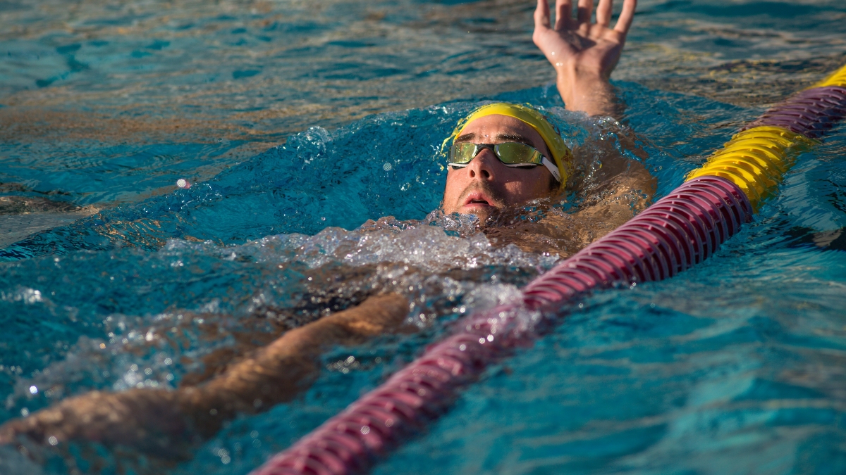 man swimming backstroke in a pool