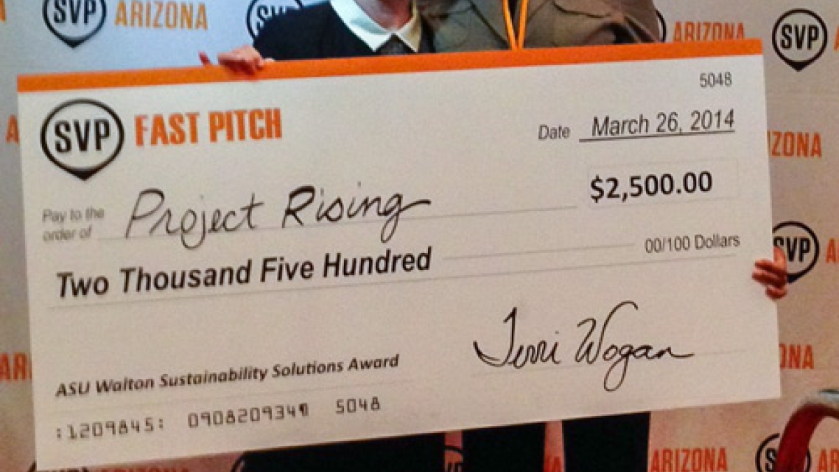 two women holding a check at SVP Fast Pitch competition