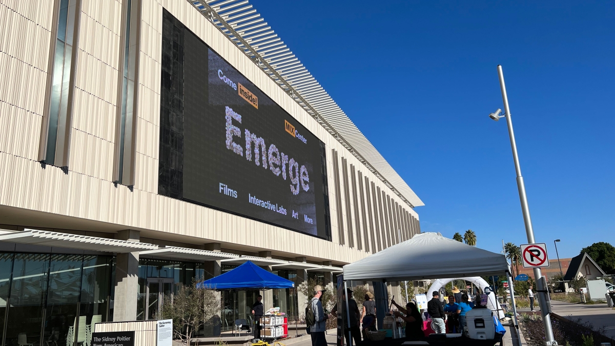 Exterior of the MIX Center with a logo for the Emerge event on large outdoor screen.