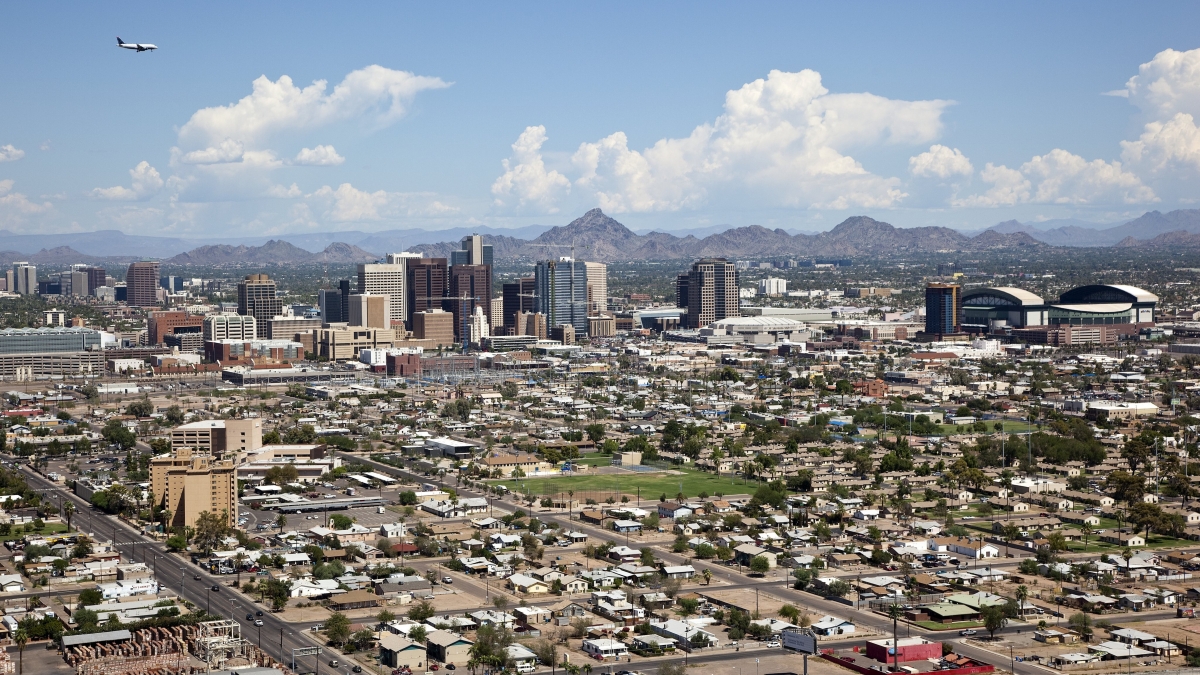 aerial image of downtown Phoenix, Arizona with flying airplane