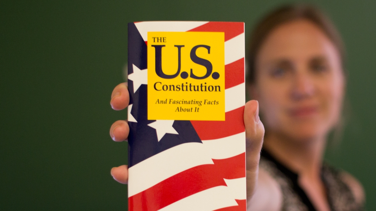 woman holding pocket US Consititution