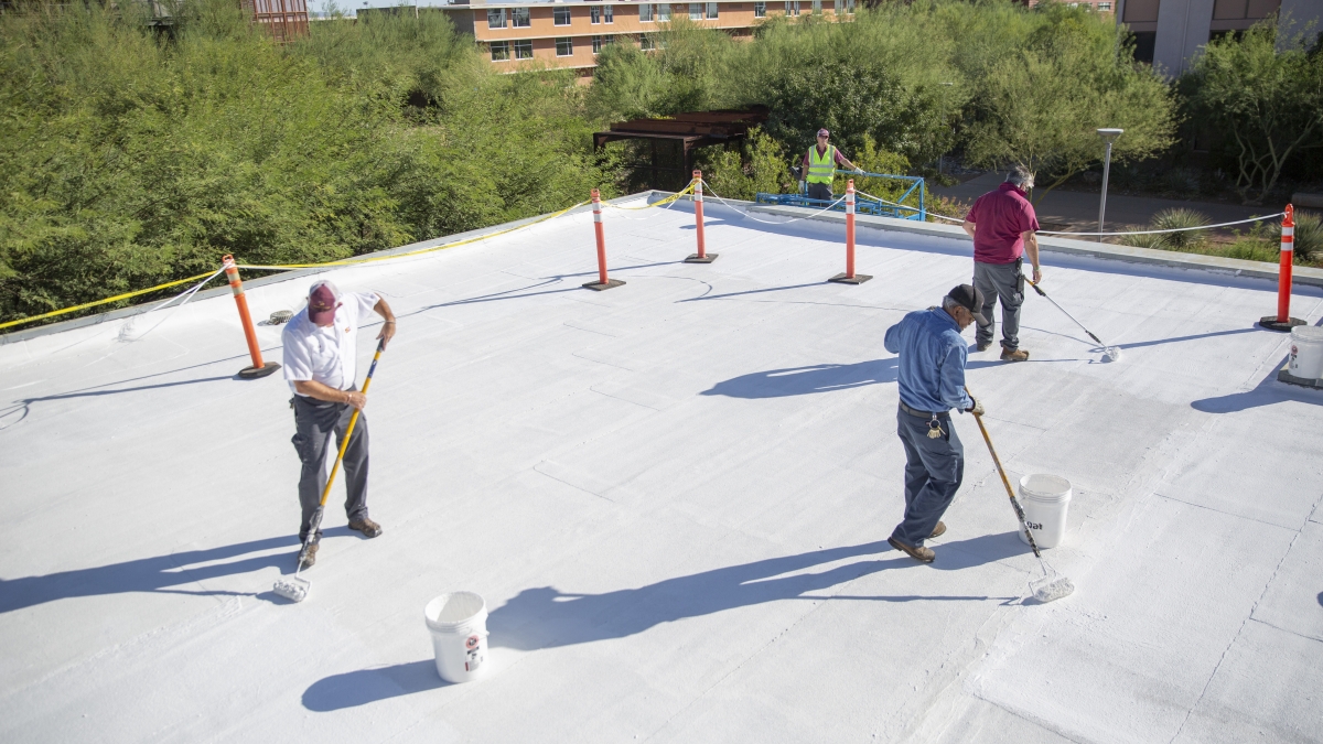 ASU employees apply coating to roof of Polytechnic campus building