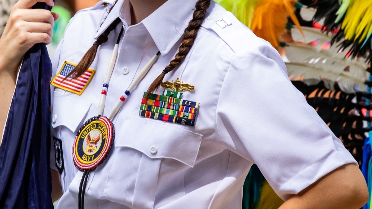 ASU student Rachelle Edwards holding a flag and wearing Veterans Honor Guard regalia.