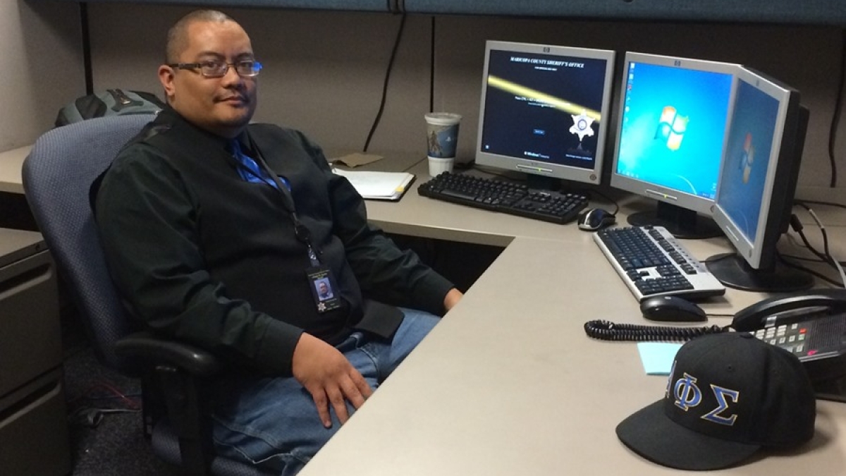ASU student Richie Del Rio sitting at his desk at his internship