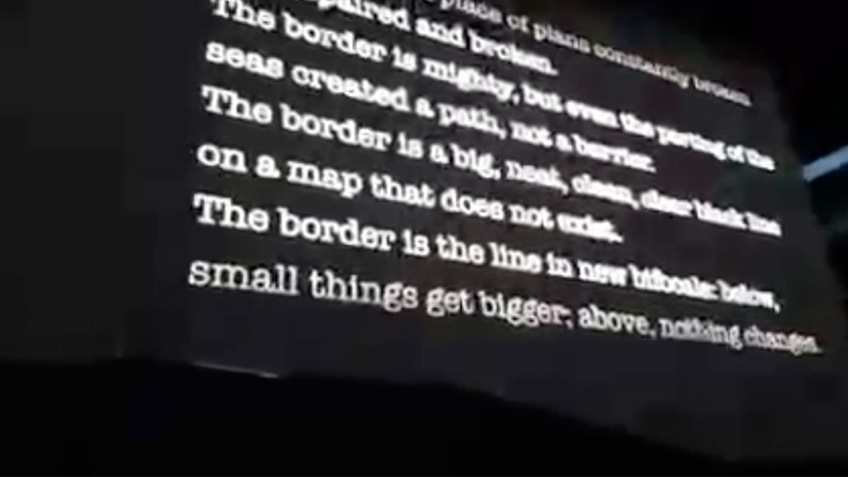 ASU Professor Alberto Rios poem on screen at U2 concert