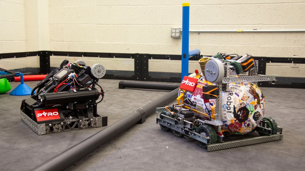Two robots from Arizona State University’s Rossum Rumblers VEX Robotics competition team, PYRO, sit in the team’s practice arena on ASU’s Polytechnic campus.