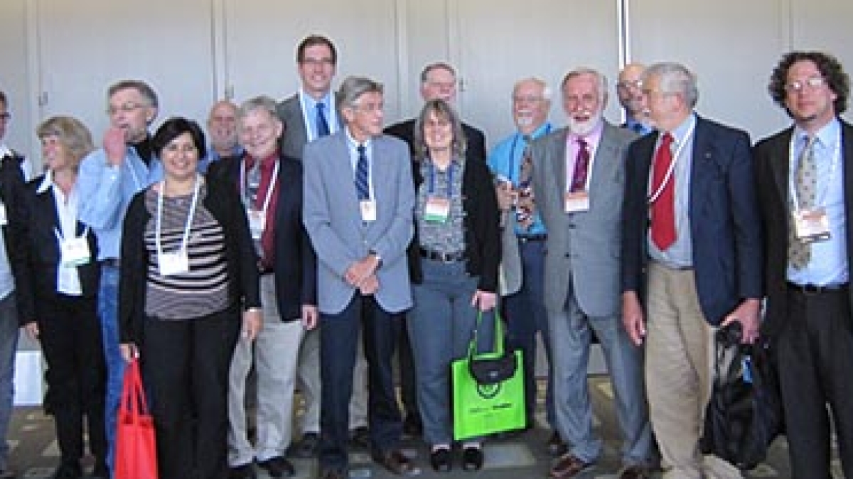 Regents' Professor Emeritus Geoffrey Clark surrounded by symposium attendees