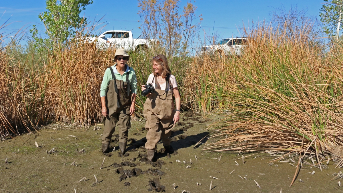 Sally Wittlinger and Lindsey Rustad stand in mud at Tres Rios, Arizona