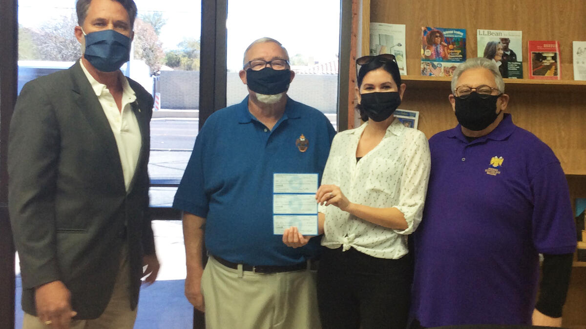 Members of Phoenix Scottish Rite Foundation Mike Bernhardt, Curtis White and Tony Darin present checks to College of Health Solutions development officer Alma Strasser.