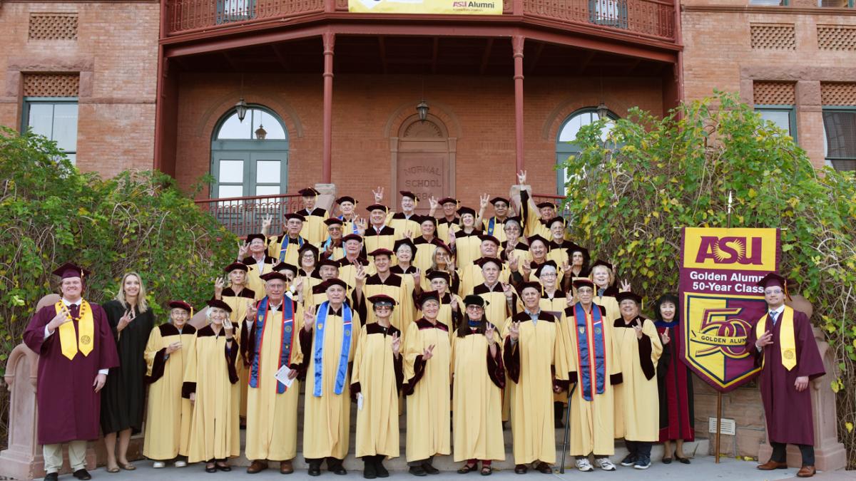 Group photo of ASU alumni from the classes of 1970 and 1971 on the steps of Old Main on the Tempe campus.