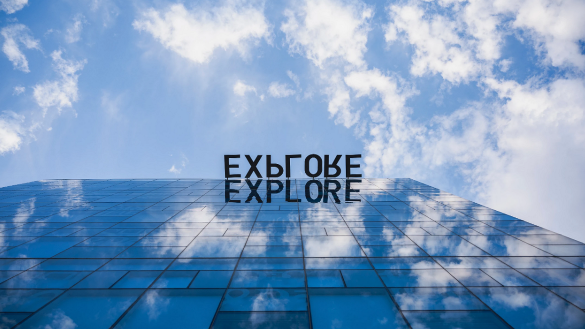 Photo of the "explore" sign at the top of Coor Hall on ASU's Tempe campus.