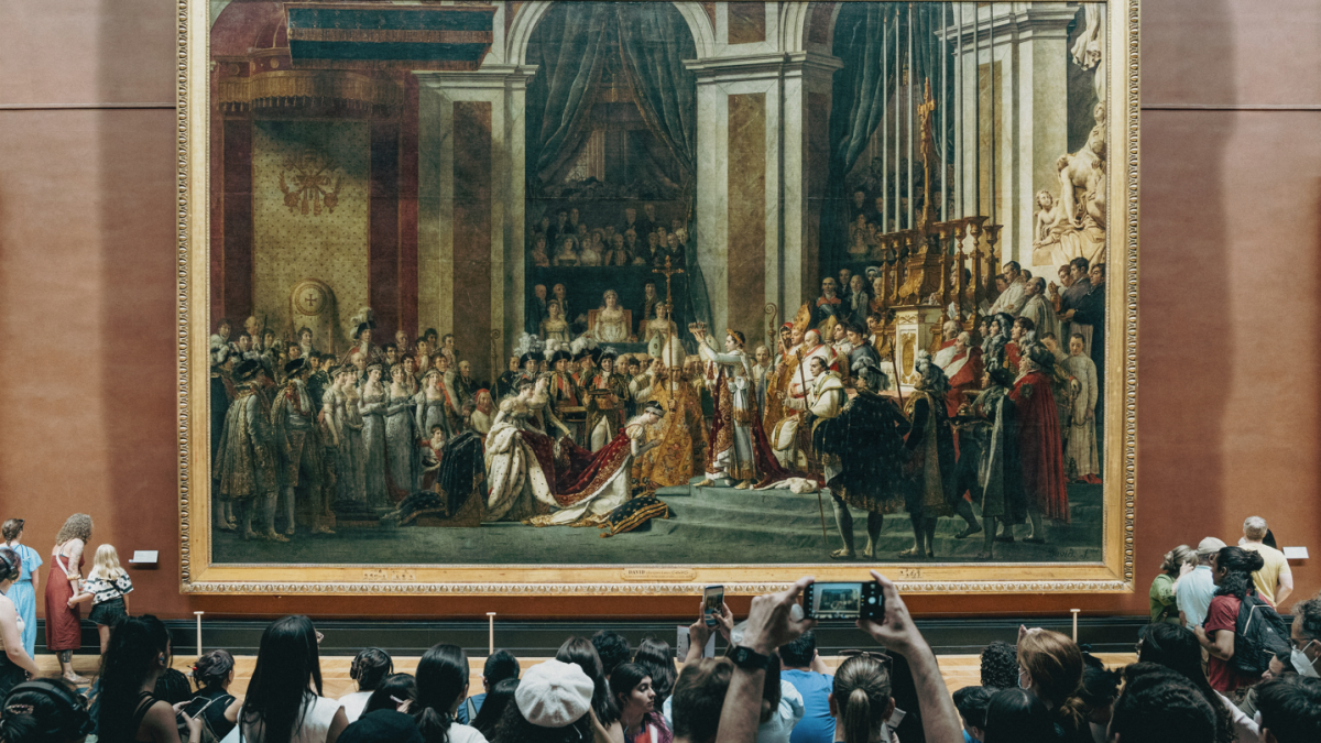 Photo of a crowd in front of a painting depicting a king's coronation