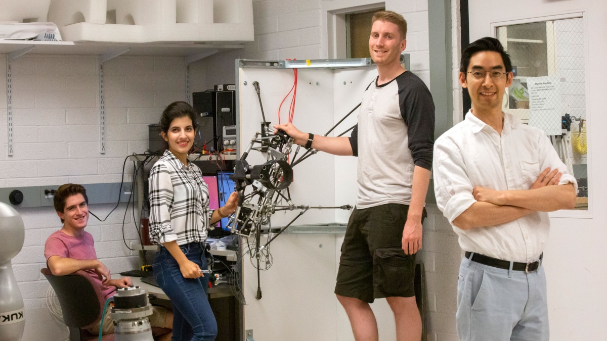 Hyunglae Lee (right) poses with his students in the Neuromuscular Control and Human Robotics Laboratory