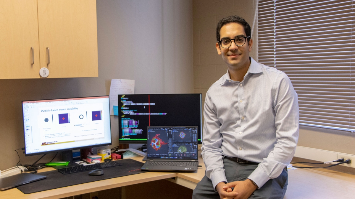 Mohamed Houssem Kasbaoui, an assistant professor of mechanical and aerospace engineering in the Ira A. Fulton Schools of Engineering at ASU, poses in his lab with representations of semi-dilute dusty flows simulation research.