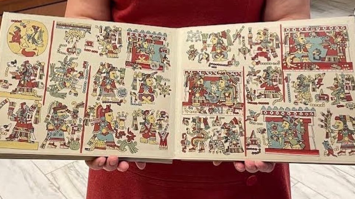 Seonaid Valiant, curator for Latin American studies at the ASU Library, holds a facsimile of the Codex Nuttall.