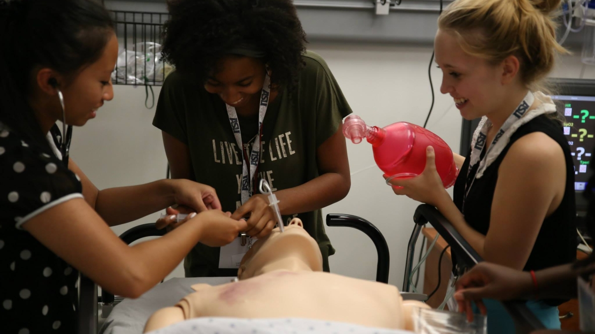 high school students practicing intubation on a dummy