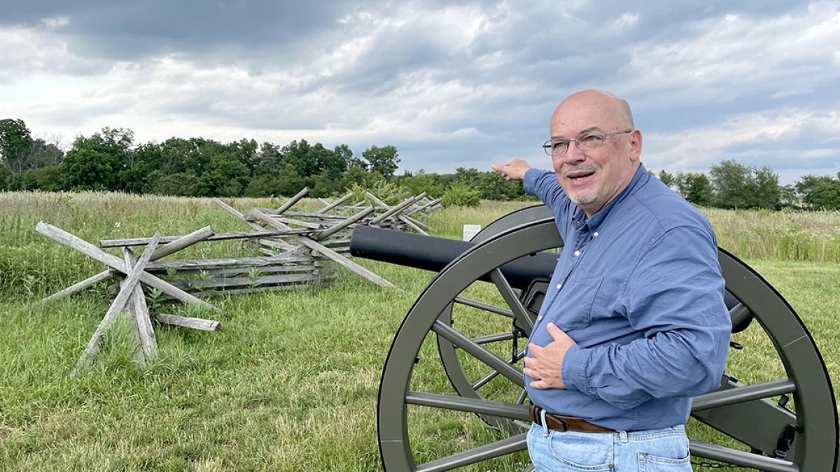 Brooks Simpson next to Civil War replica cannons on the Gettysburg battlefield.