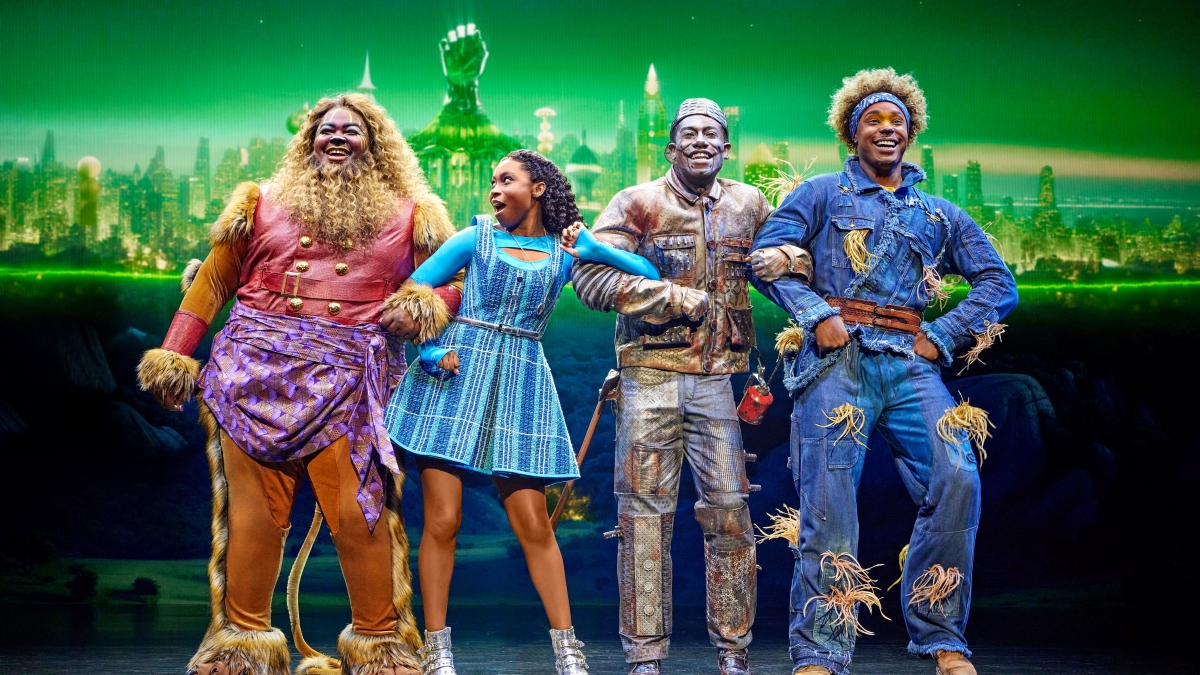 People in costumes performing 'The Wiz' onstage.