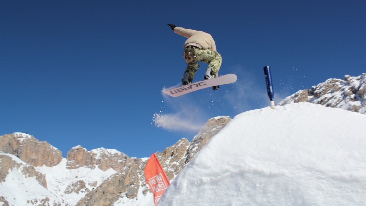 Snowboarder mid-jump.