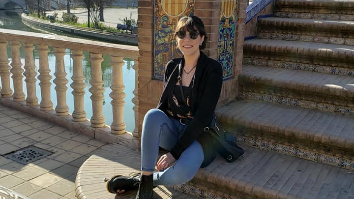 Sabrina Petrovski sitting on stairway outdoors in Spain