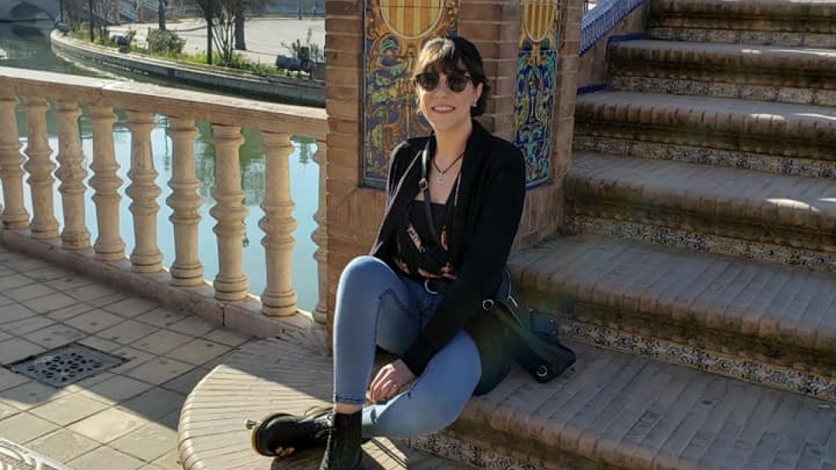 Sabrina Petrovski sitting on stairway outdoors in Spain