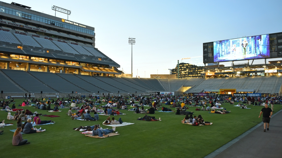 Guests sit on the field at Sun Devil Stadium