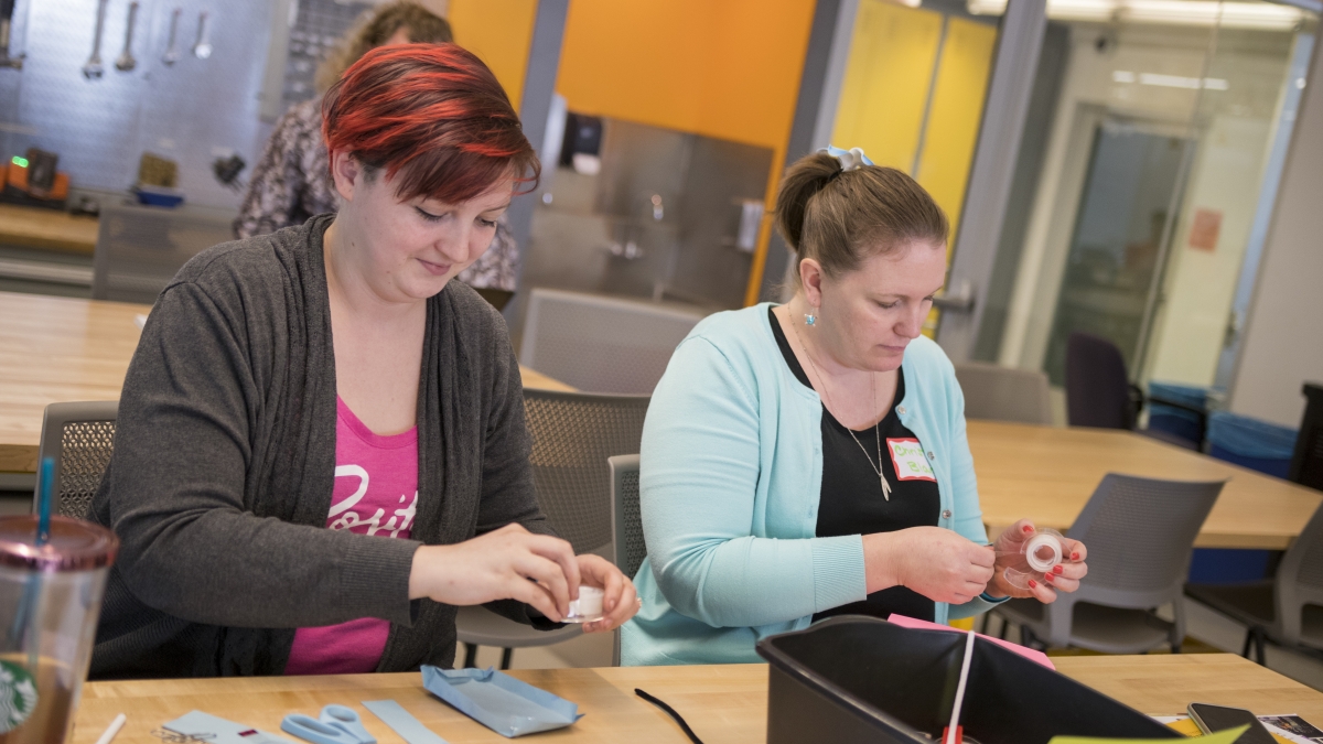 Two participants in the STEMteachersPHX Conference build prototype of a smartphone case