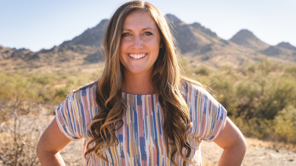 Photo of ASU alum and former track and field team member Stephanie Mundt smiling in a desert setting.