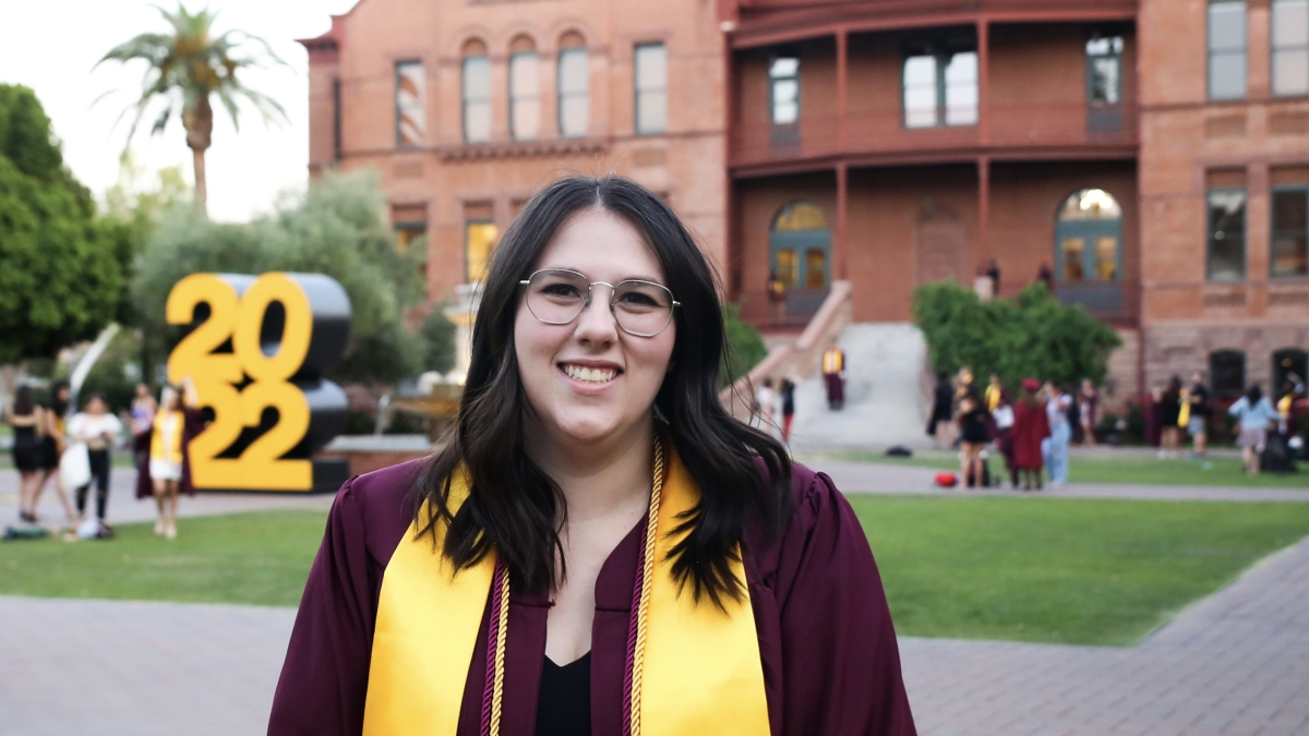 Portrait of ASU grad Stephanie Gerhart in front of the Old Main building on the Tempe campus.