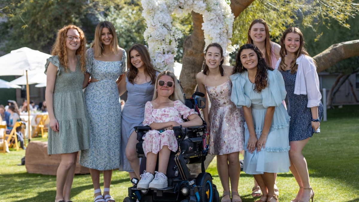 A group of female students pose for a photo outdoors at the Barrett Honors College Ladies' Tea.