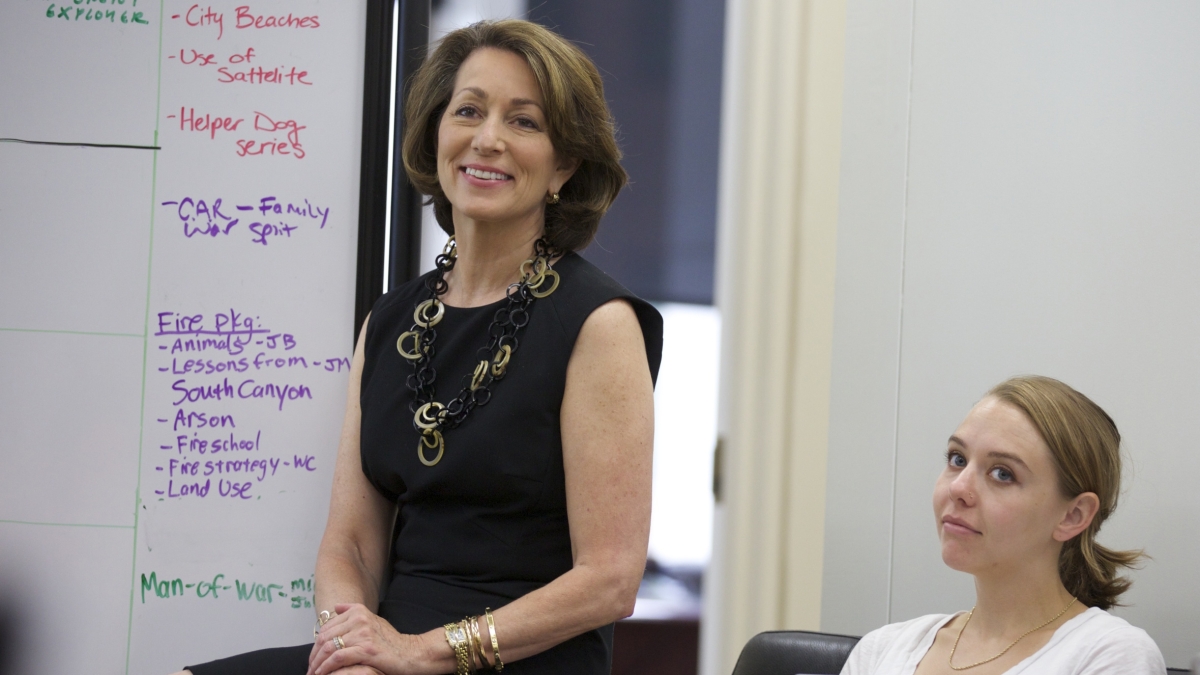 Former National Geographic Editor-in-Chief and current ASU Cronkite School Vice Dean Susan Goldberg leading an editorial meeting, standing in front of a whiteboard.