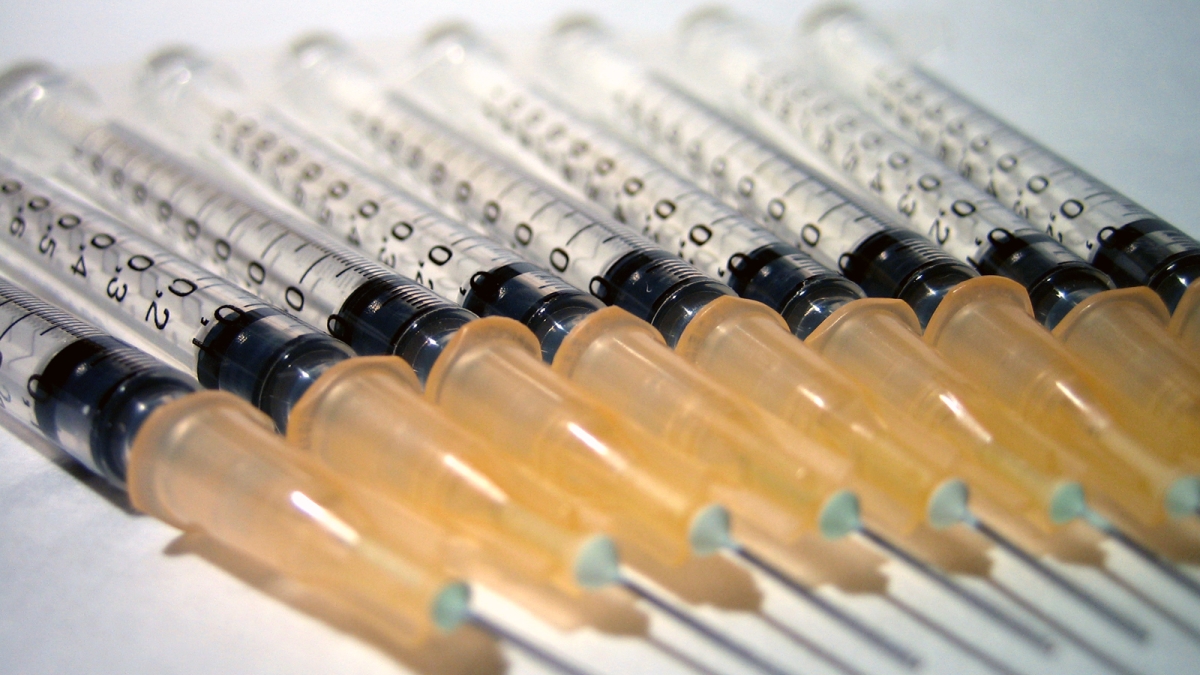 A photograph of medical syringes and needles